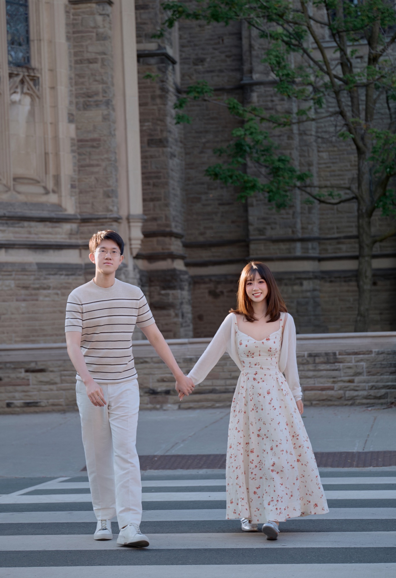 A couple walking hand in hand across a street