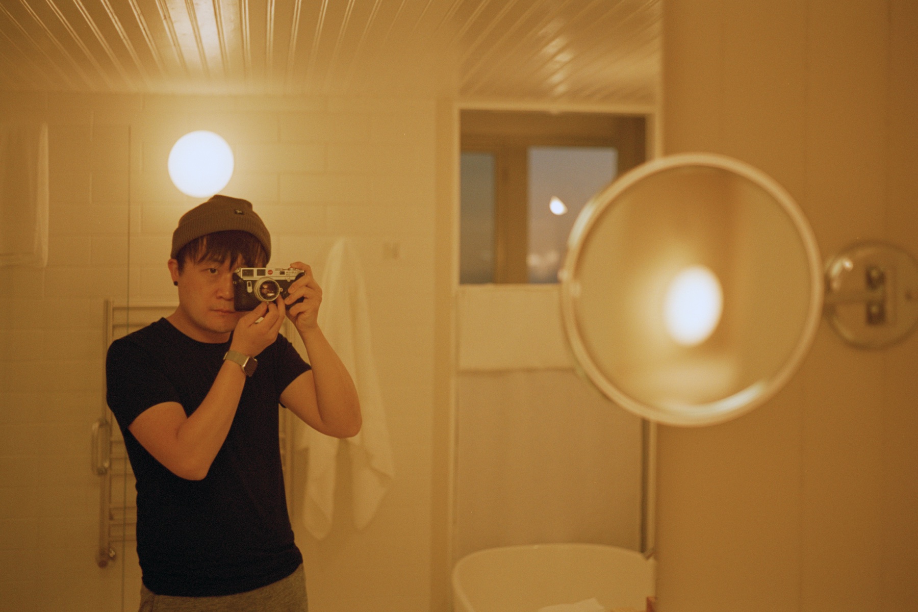 The photographer behind D Vision taking a mirror self-portrait