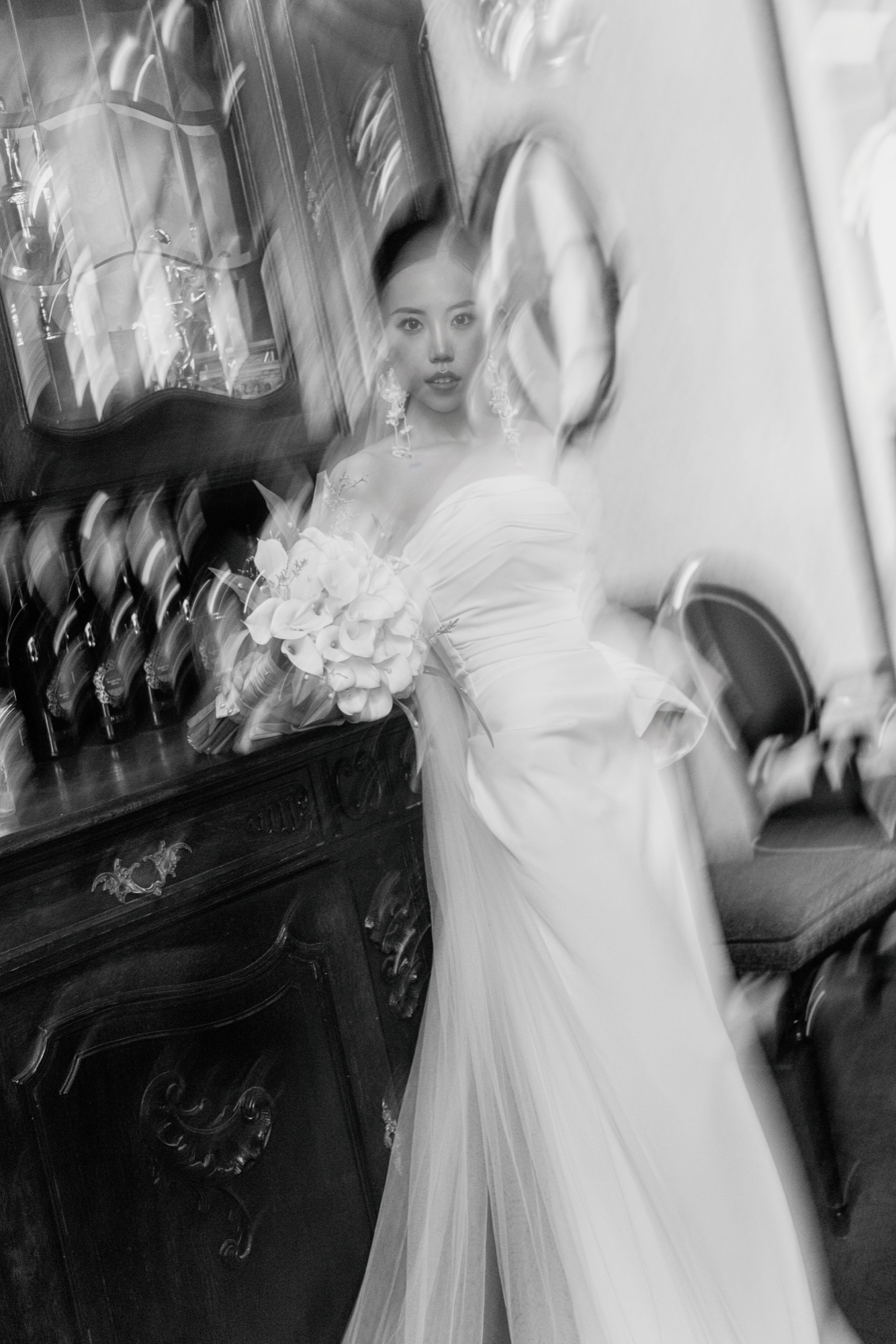 A black and white bridal portrait through blurred glass details